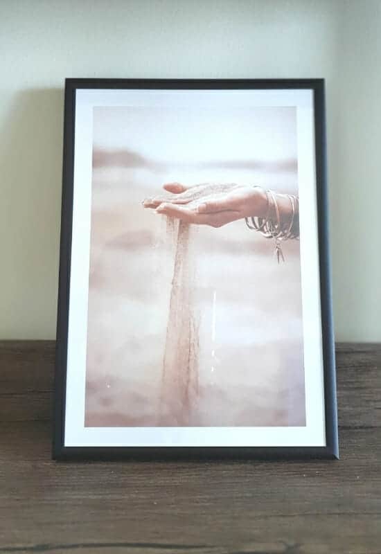 Sand falling through hand poster