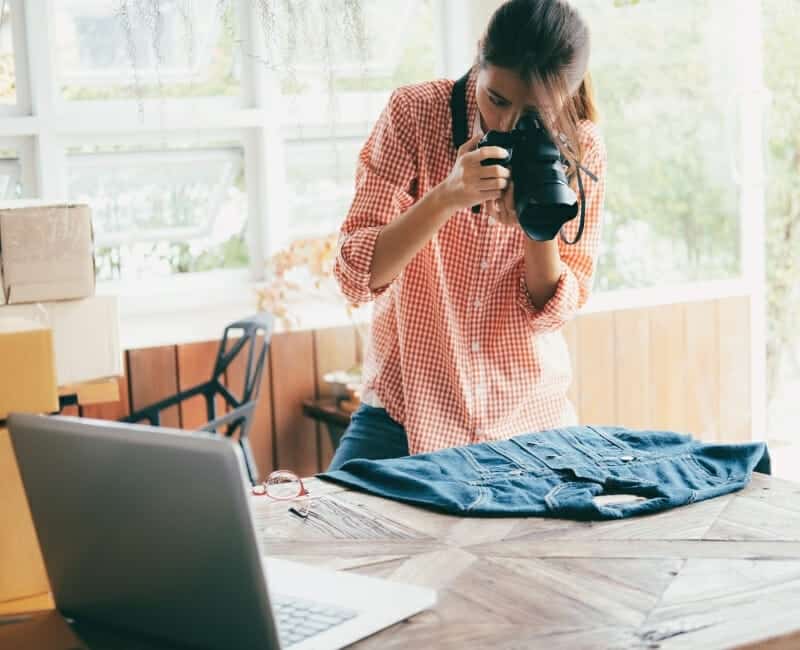 Why-you-shouldnt-sell-your-stuff-after-decluttering-woman-photographing-shirt-to-sell-online