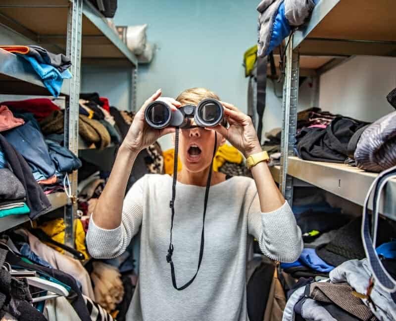 Why-you-shouldnt-sell-your-stuff-after-decluttering-woman-standing-in-cluttered-closet