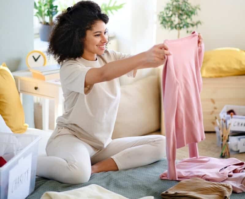 Woman decluttering clothes