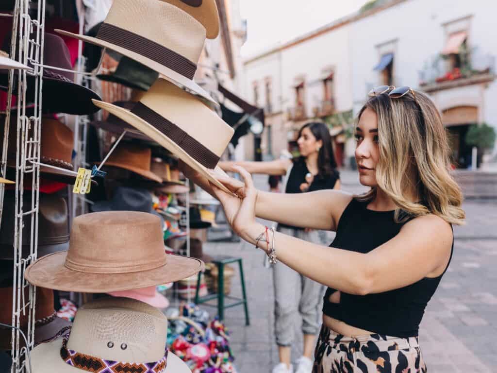 Two women shopping for hats