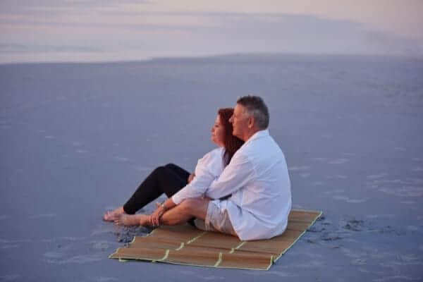 The art of slow living Couple sitting on the beach