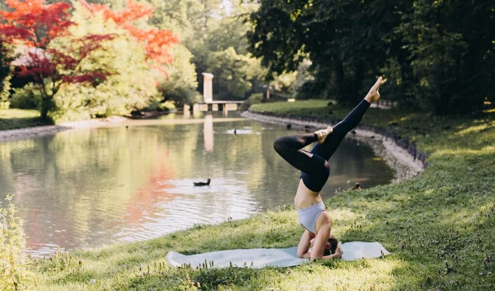 How to slow down: Woman doing yoga by a lake