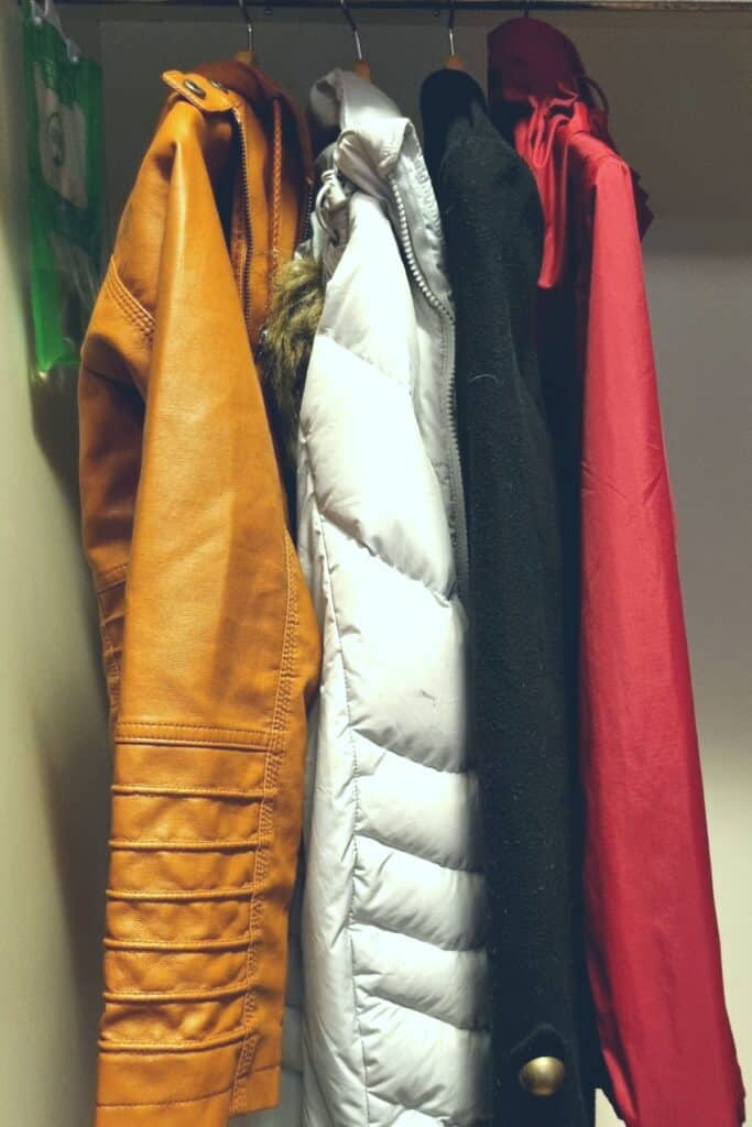 Four coats hanging in my minimalist wardrobe